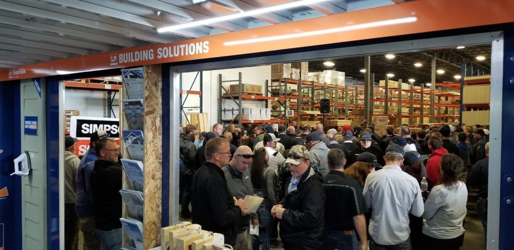 A room packed full of people at a lumber event