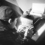 Boy typing on traditional typewriter
